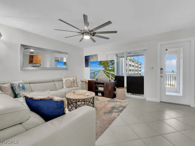 a living room with furniture a window and a chandelier