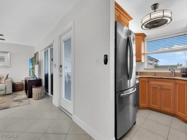 a kitchen with stainless steel appliances granite countertop a refrigerator and a sink