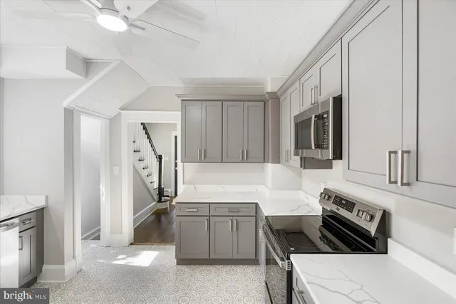 a kitchen that has a sink and a stove