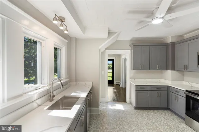 a kitchen with a sink stove and cabinets