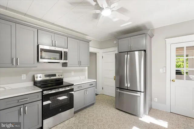 a kitchen with a refrigerator sink and stove