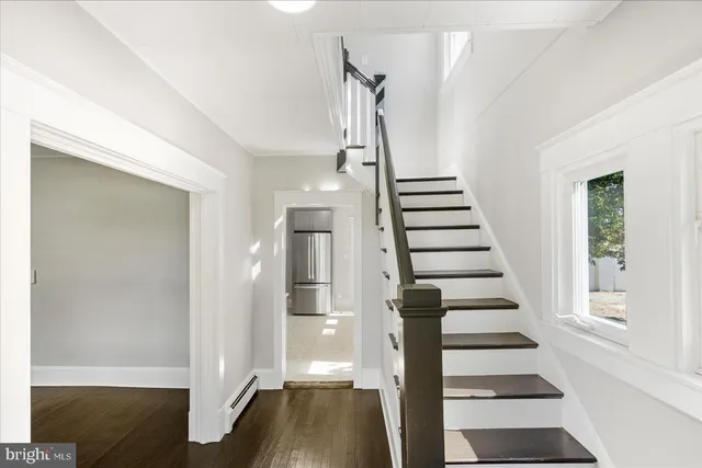 a view of entryway and hall with wooden floor