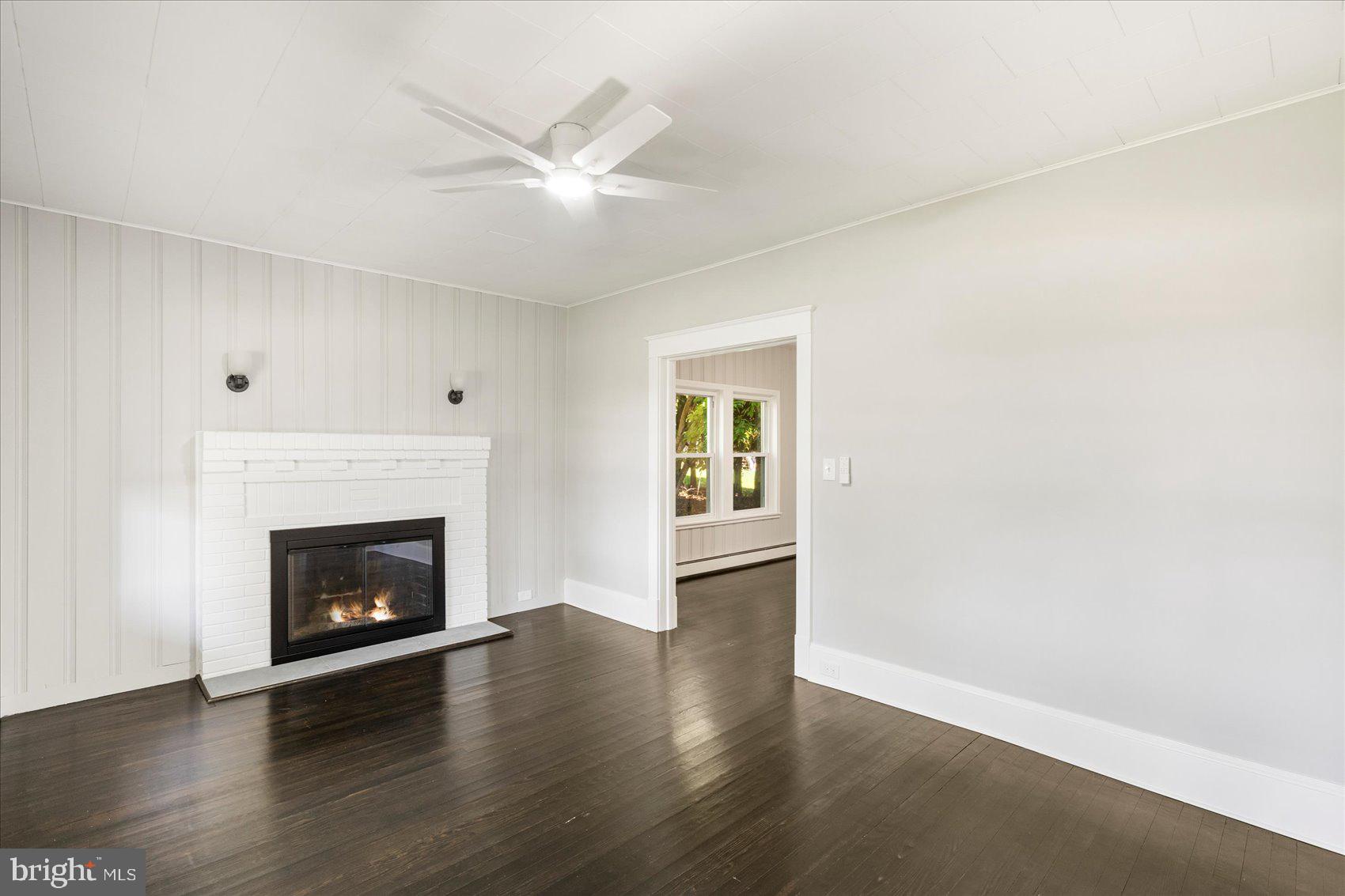 15317 York Road Sparks Glencoe, MD 21152 - Photo 4 of 47 a view of an empty room with wooden floor and a fireplace