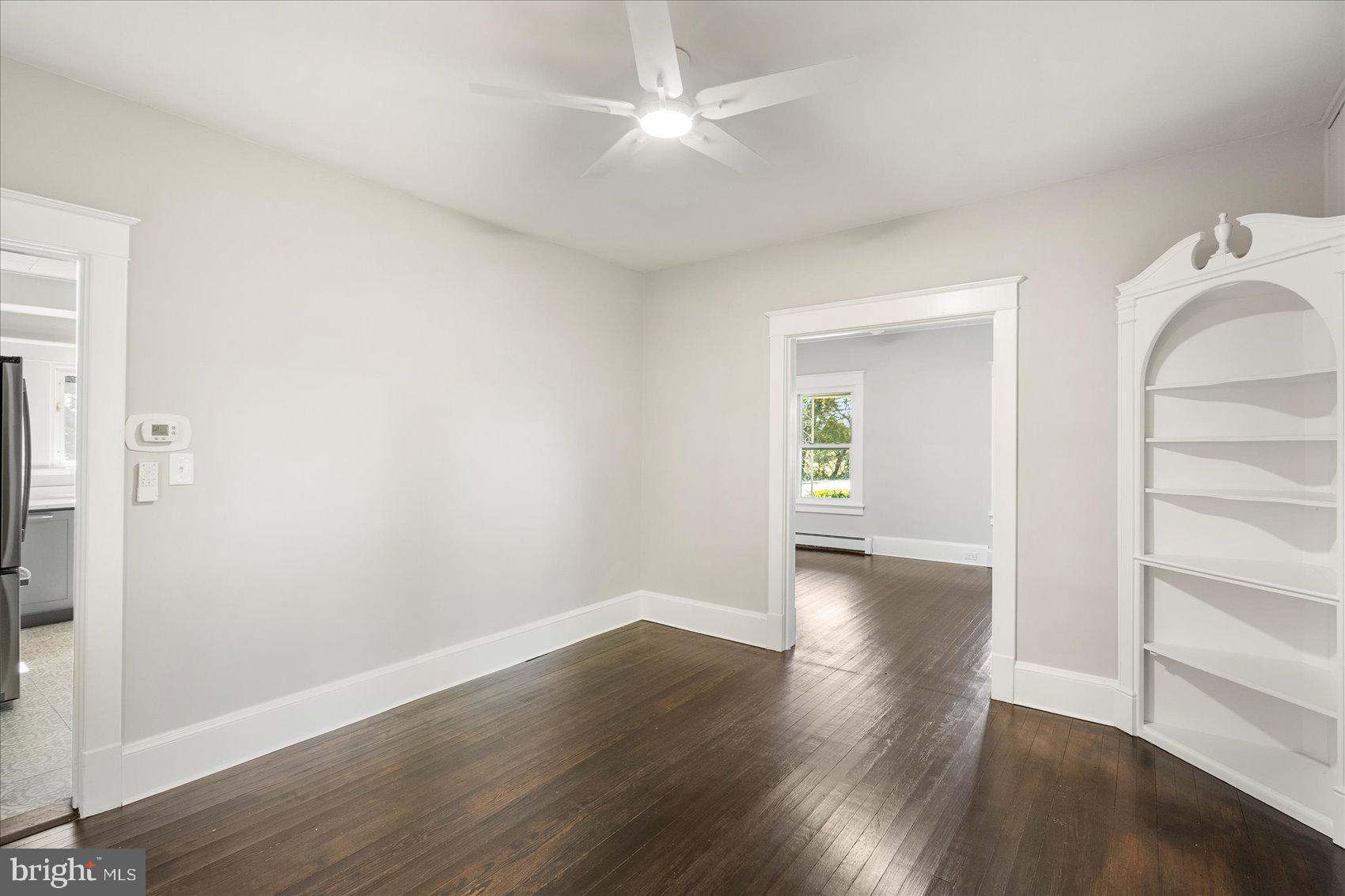15317 York Road Sparks Glencoe, MD 21152 - Photo 8 of 47 an empty room with wooden floor and a ceiling fan