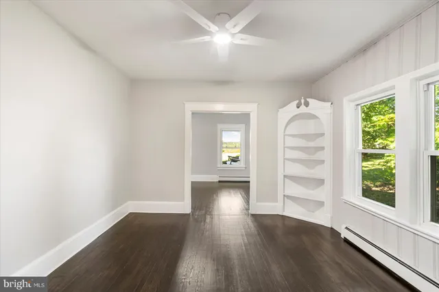 wooden floor in an empty room with a window