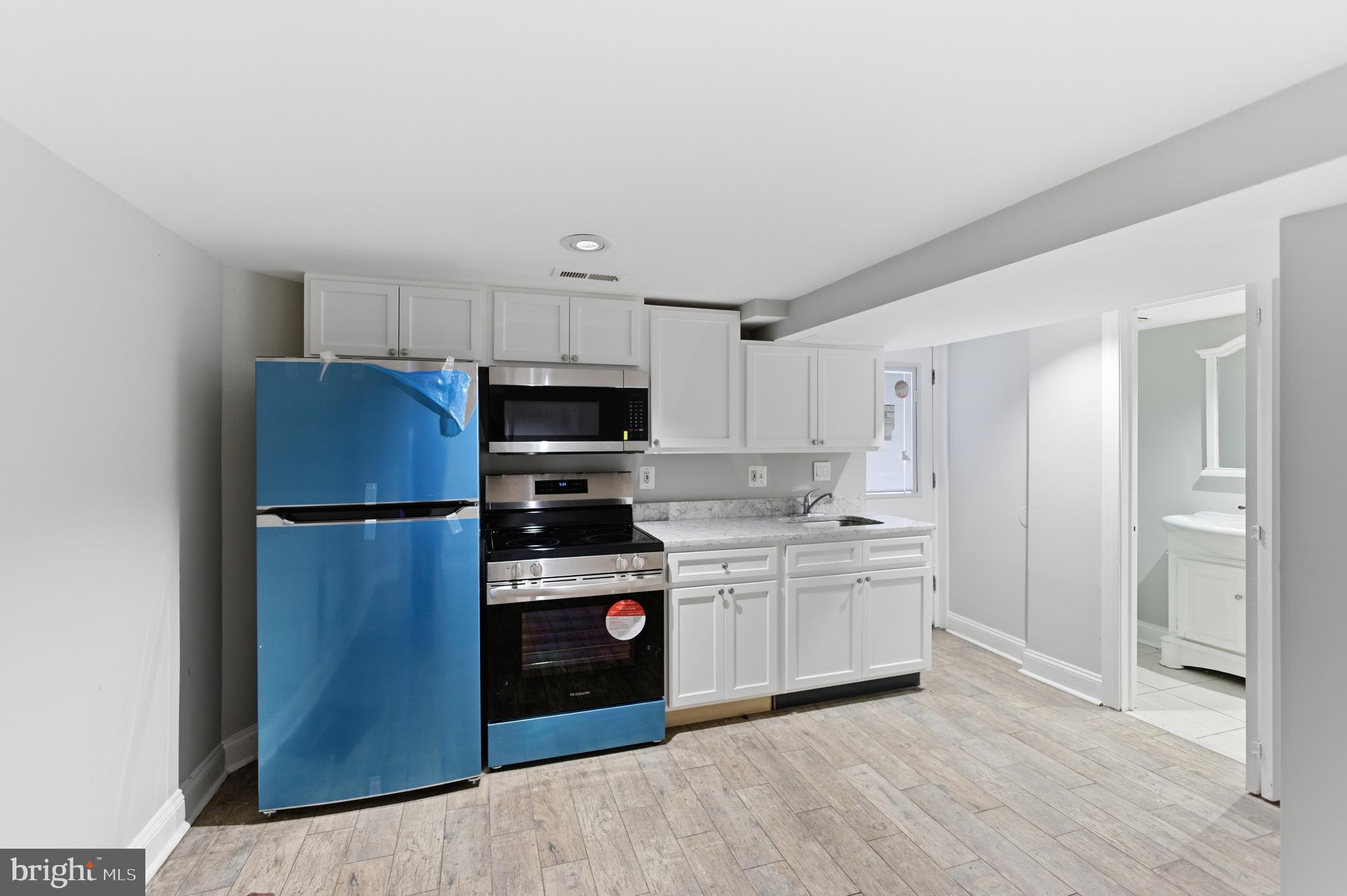 5518 13th Street Northwest, Unit B Washington, DC 20011 - Photo 5 of 8 a kitchen with stainless steel appliances a refrigerator stove and sink