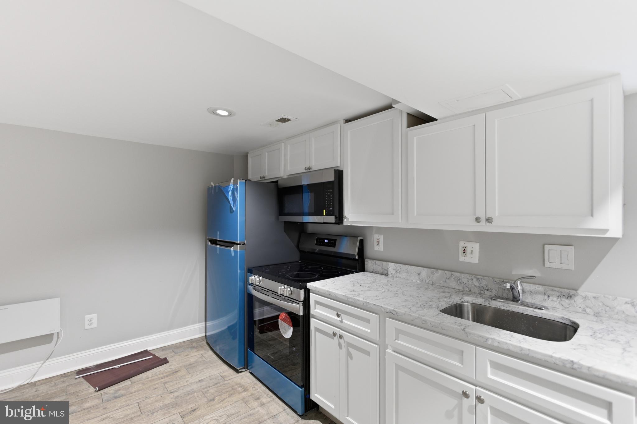 5518 13th Street Northwest, Unit B Washington, DC 20011 - Photo 6 of 8 a kitchen with a sink and cabinets