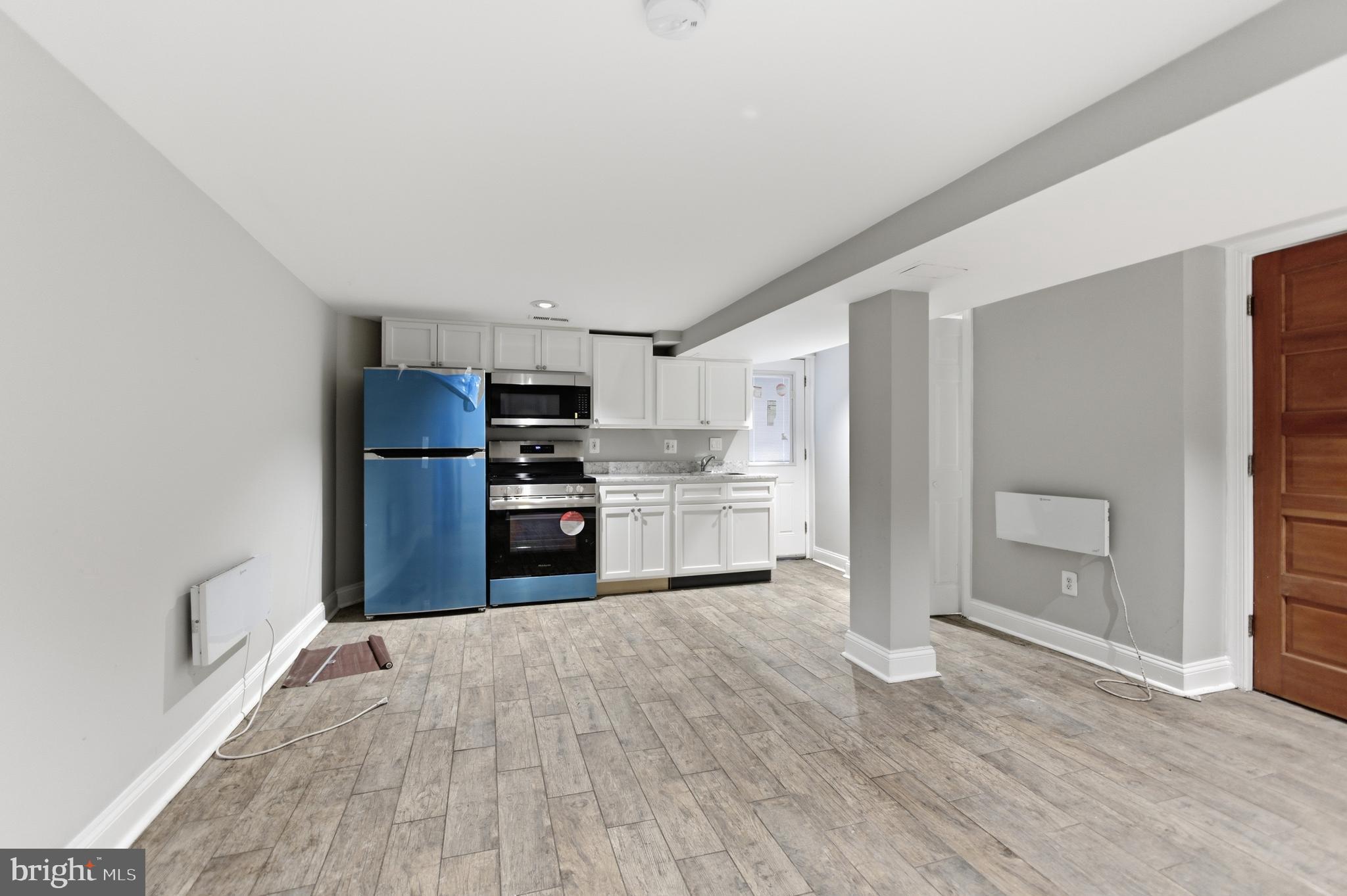 5518 13th Street Northwest, Unit B Washington, DC 20011 - Photo 7 of 8 a kitchen with stainless steel appliances a refrigerator and wooden cabinets