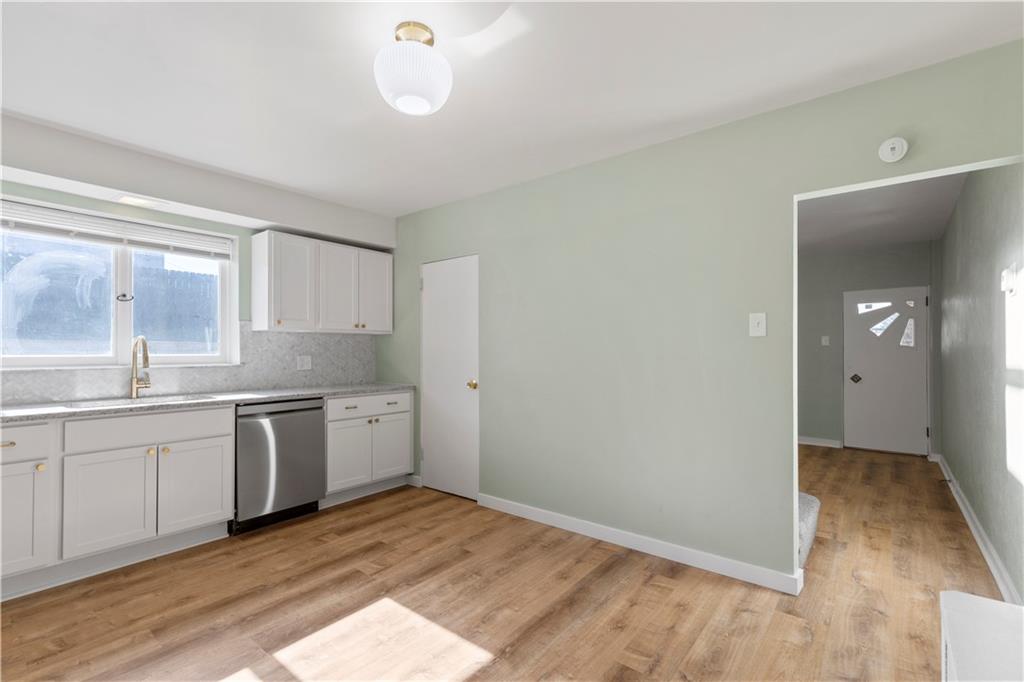 411 Edith Street Pittsburgh, PA 15211 - Photo 11 of 31 a view of a kitchen with a sink cabinets and wooden floor