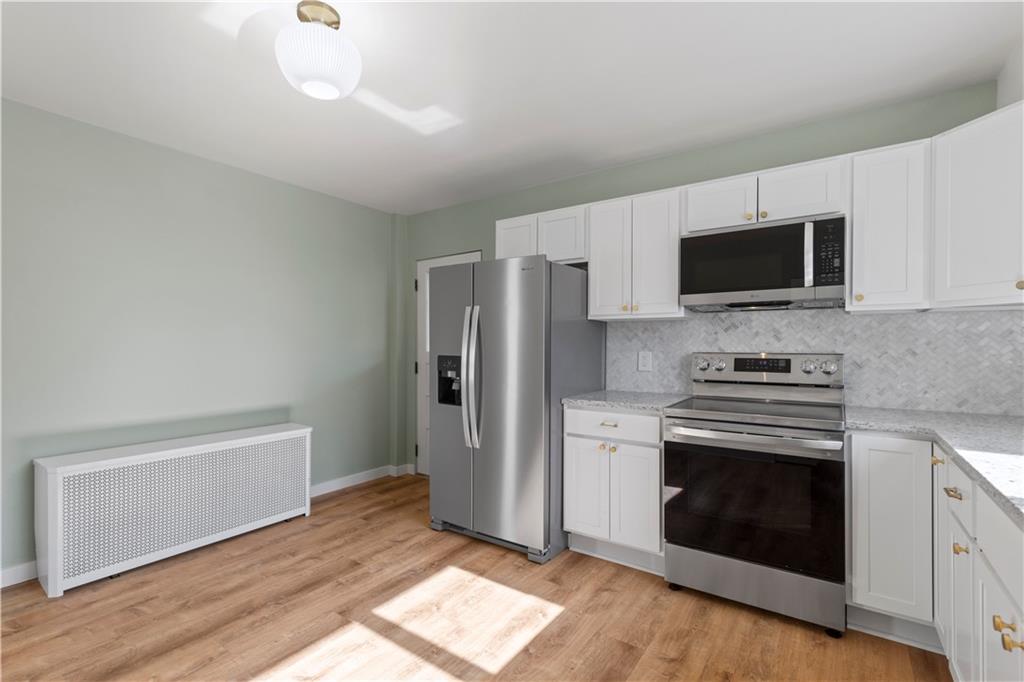 411 Edith Street Pittsburgh, PA 15211 - Photo 12 of 31 a kitchen with a stove and a microwave