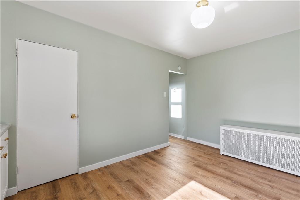 411 Edith Street Pittsburgh, PA 15211 - Photo 13 of 31 a view of an empty room with wooden floor and a window