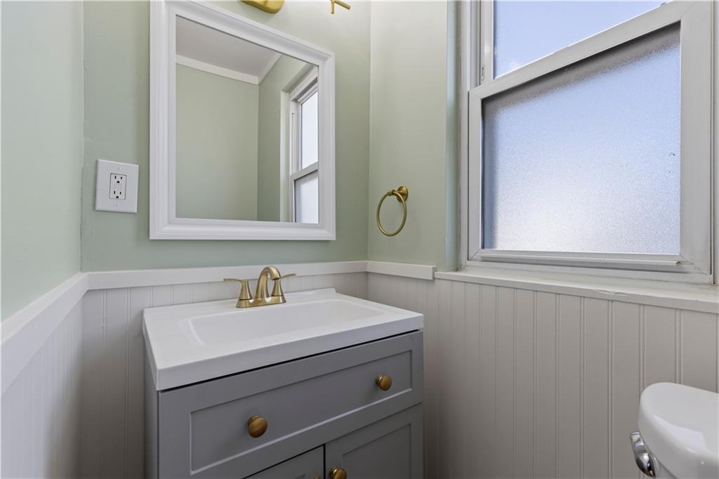 411 Edith Street Pittsburgh, PA 15211 - Photo 20 of 31 a bathroom with a sink a mirror and a toilet