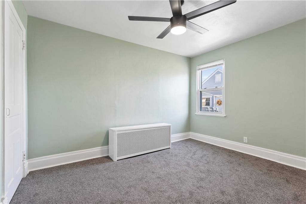 411 Edith Street Pittsburgh, PA 15211 - Photo 21 of 31 an empty room with a ceiling fan and window