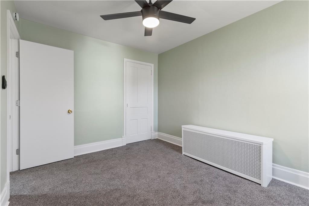 411 Edith Street Pittsburgh, PA 15211 - Photo 22 of 31 an empty room with a ceiling fan and a window