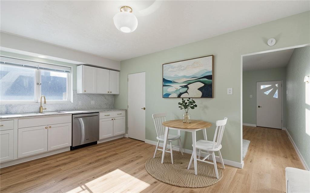 411 Edith Street Pittsburgh, PA 15211 - Photo 4 of 31 a kitchen with granite countertop a sink cabinets and wooden floor