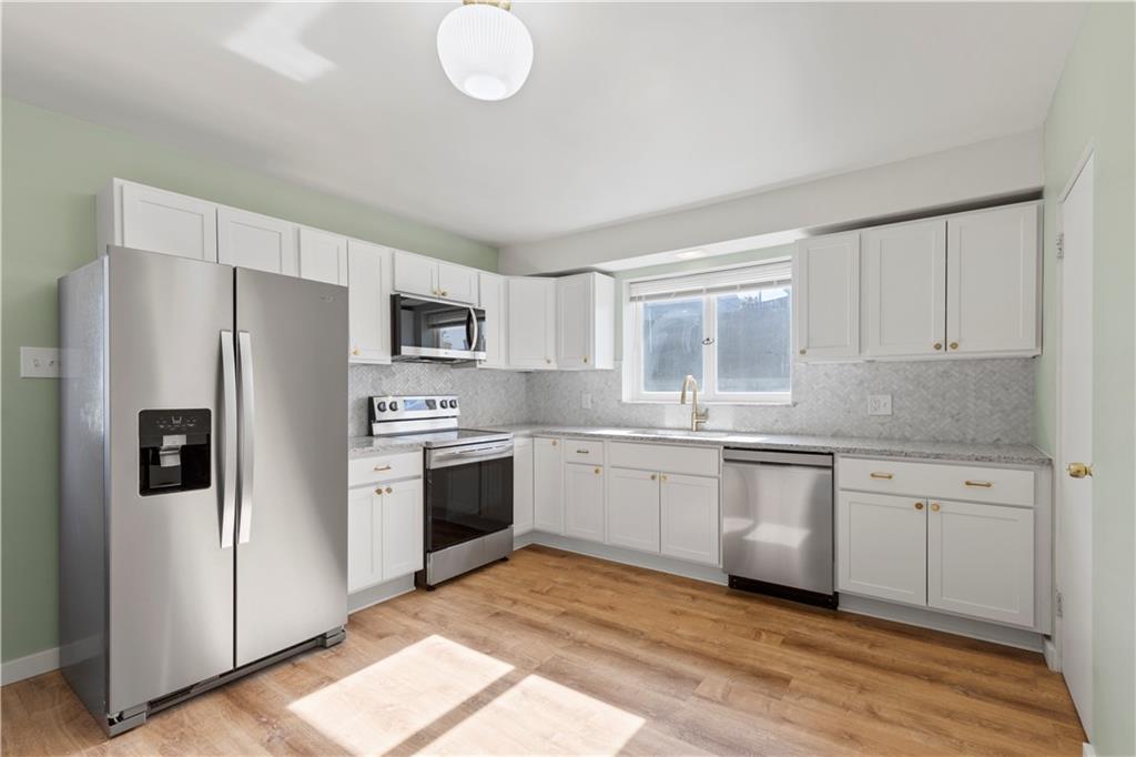 411 Edith Street Pittsburgh, PA 15211 - Photo 10 of 31 a kitchen with stainless steel appliances granite countertop a refrigerator sink and stove