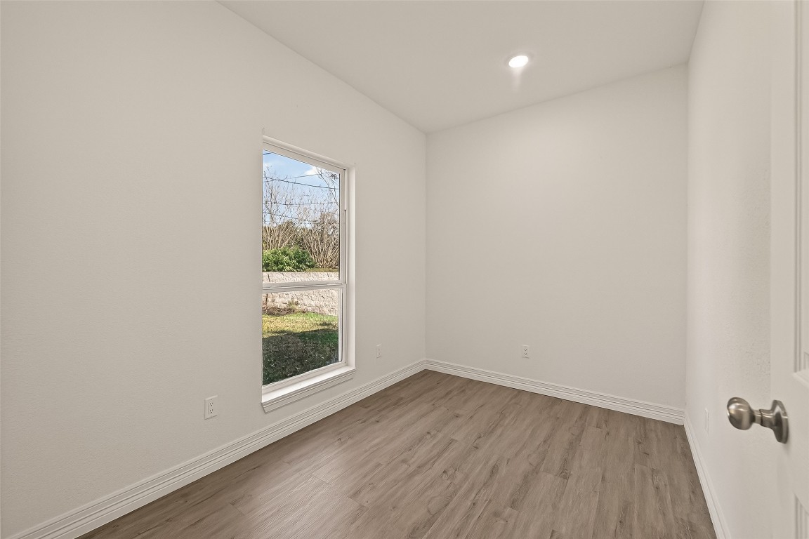 2609 Boss Street La Marque, TX 77568 - Photo 15 of 33 a view of an empty room with wooden floor and a window