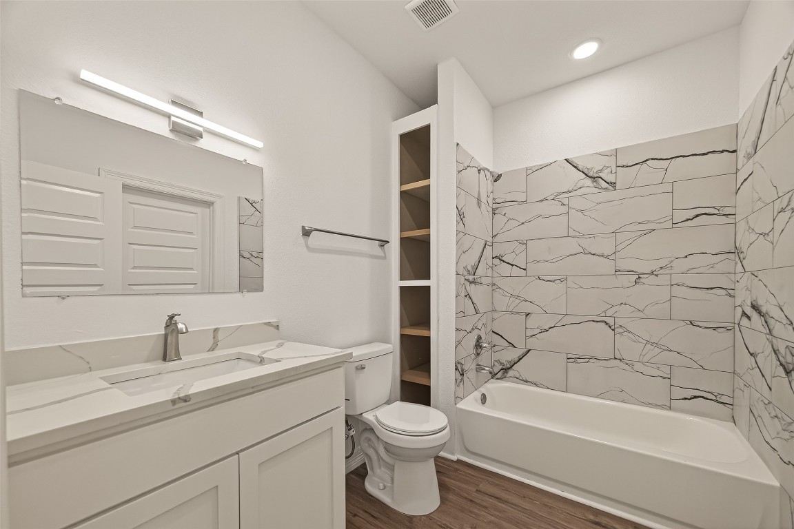 2609 Boss Street La Marque, TX 77568 - Photo 20 of 33 a bathroom with a granite countertop sink a toilet and shower