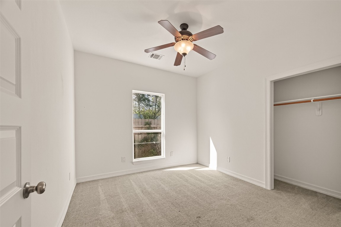 2609 Boss Street La Marque, TX 77568 - Photo 21 of 33 an empty room with windows and fan