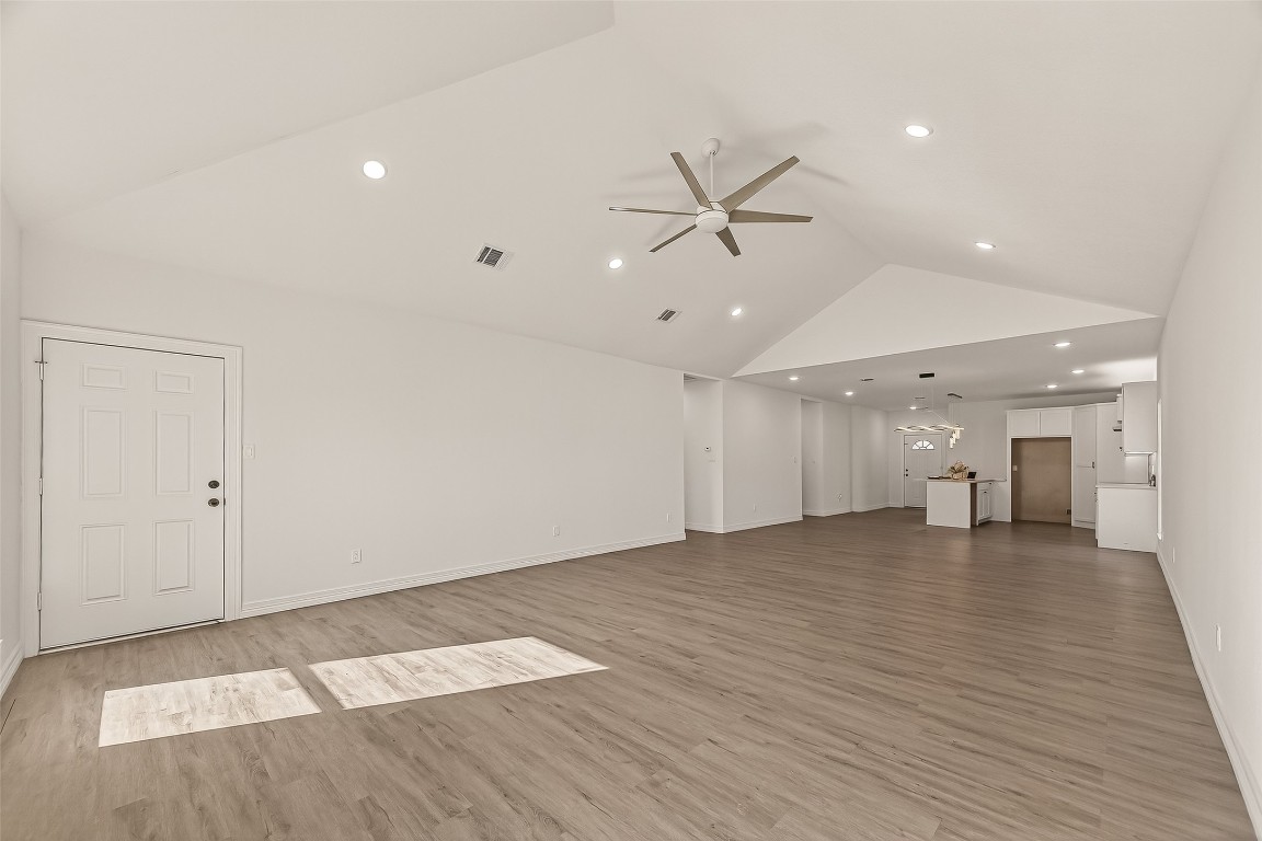 2609 Boss Street La Marque, TX 77568 - Photo 7 of 33 a view of an empty room with wooden floor and a ceiling fan