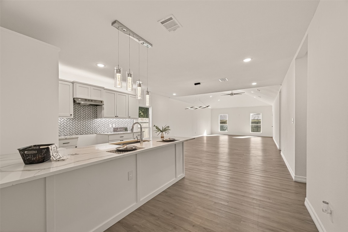 2609 Boss Street La Marque, TX 77568 - Photo 8 of 33 a kitchen with stainless steel appliances granite countertop a sink refrigerator and a stove with wooden floor