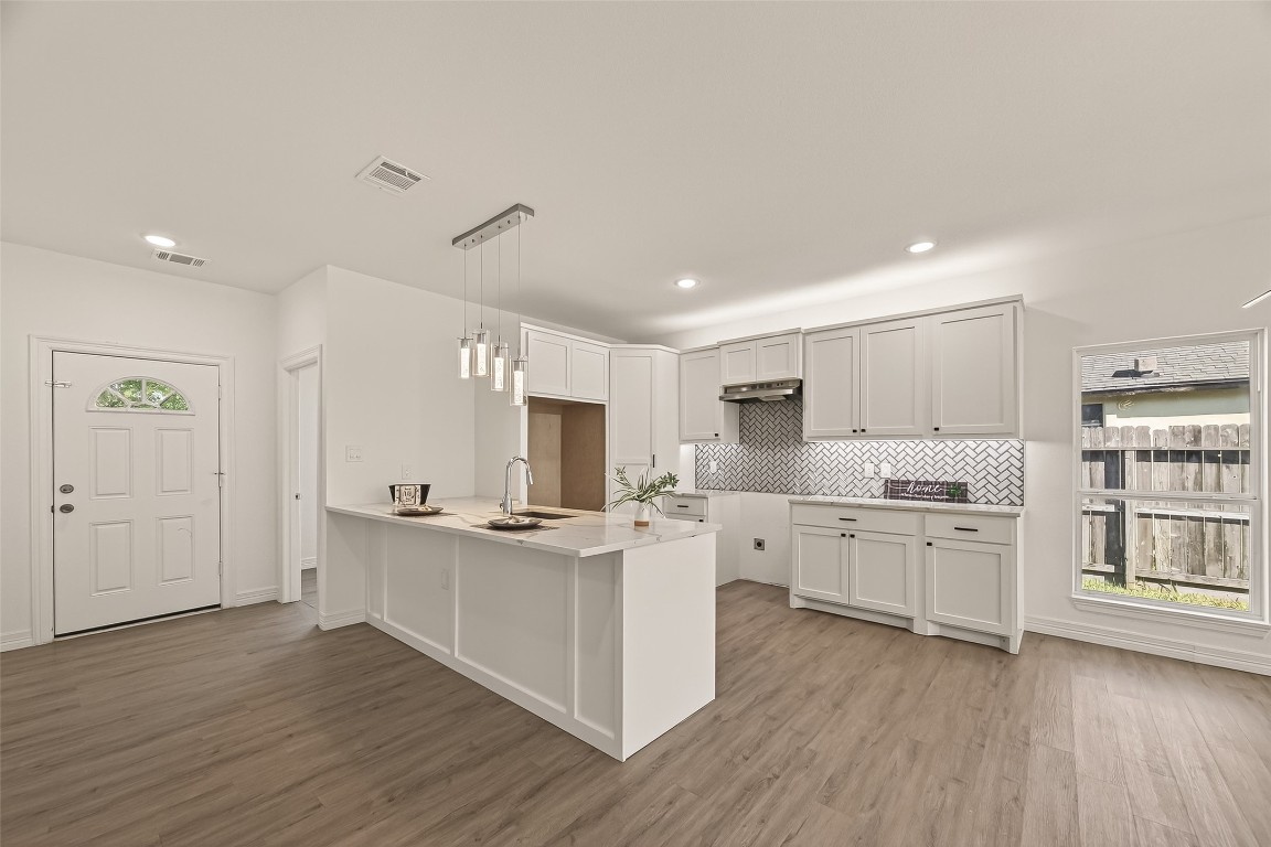 2609 Boss Street La Marque, TX 77568 - Photo 9 of 33 a kitchen with stainless steel appliances granite countertop a stove cabinets and wooden floor