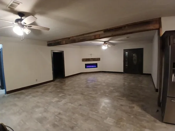 a view of a livingroom with a ceiling fan and window