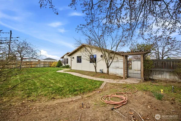 a view of backyard of house with green space