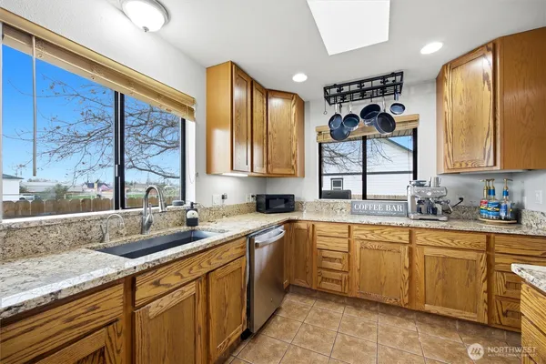 a kitchen with a sink cabinets and window