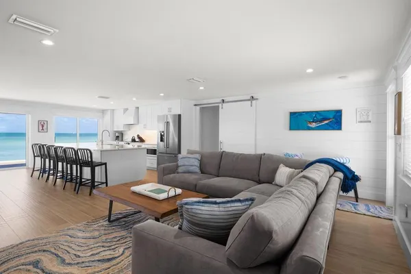 a living room with furniture and kitchen view
