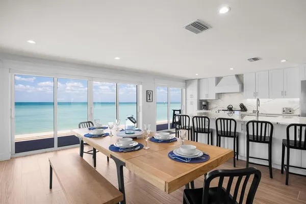a open dining room with furniture window and wooden floor