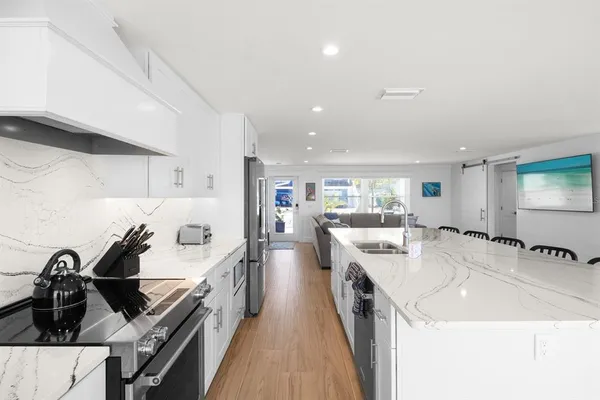 a kitchen with a sink stove and cabinets