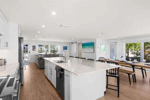 a large kitchen with a table and chairs