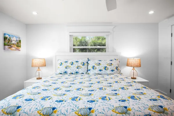 a bedroom with a bed and a lamp