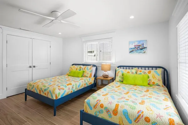 a bedroom with two beds and a window