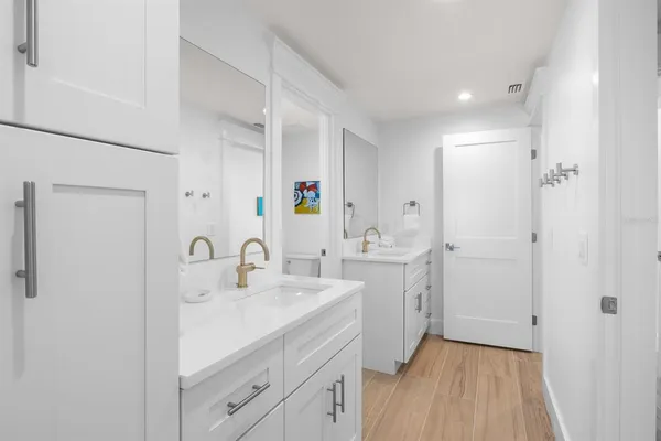 a bathroom with a sink a mirror and a shower