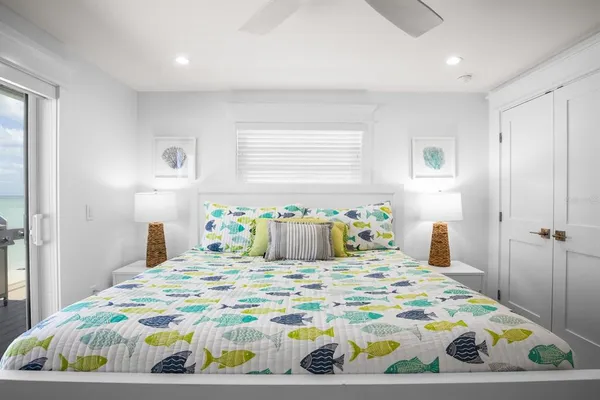 a bedroom with a bed and painting on the wall