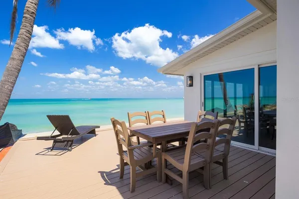 a view of a patio with table and chairs and potted plants