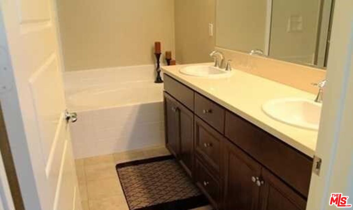 20329 Paseo Los Arcos Porter Ranch, CA 91326 - Photo 12 of 22 a bathroom with a sink and a mirror