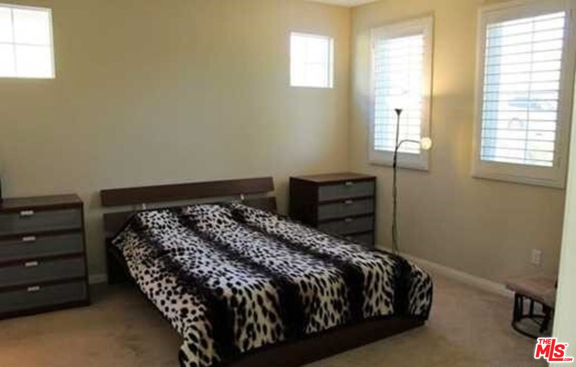 20329 Paseo Los Arcos Porter Ranch, CA 91326 - Photo 13 of 22 a bed sitting in a bedroom next to a window