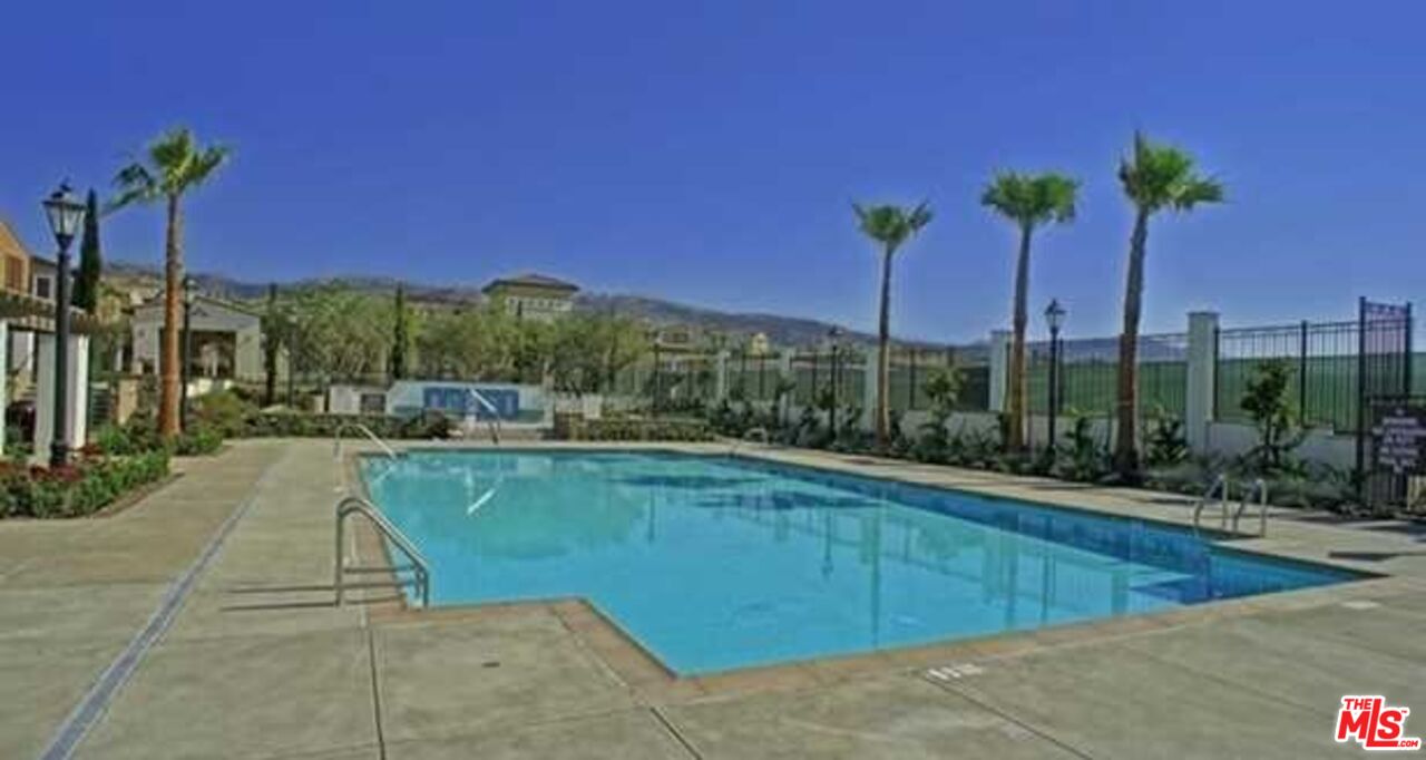 20329 Paseo Los Arcos Porter Ranch, CA 91326 - Photo 20 of 22 a view of a swimming pool with a lounge chairs
