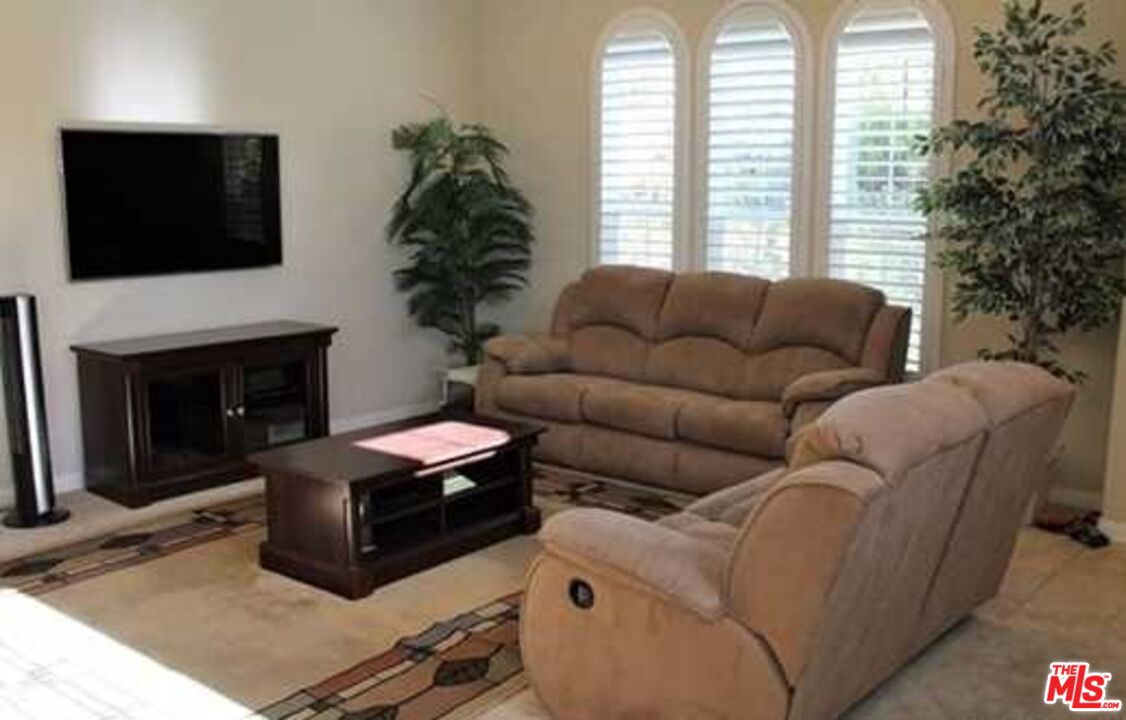 20329 Paseo Los Arcos Porter Ranch, CA 91326 - Photo 4 of 22 a living room with furniture a flat screen tv and a fireplace