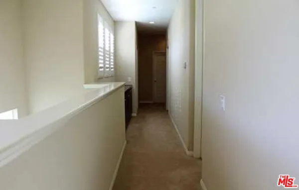 a bedroom with a bed window and a desk