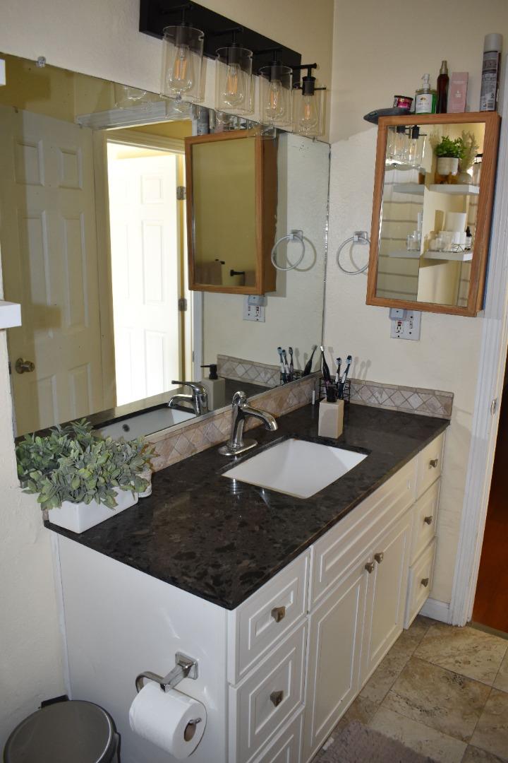 359 North 3rd Street Grover Beach, CA 93433 - Photo 13 of 23 a bathroom with a granite countertop sink and a mirror