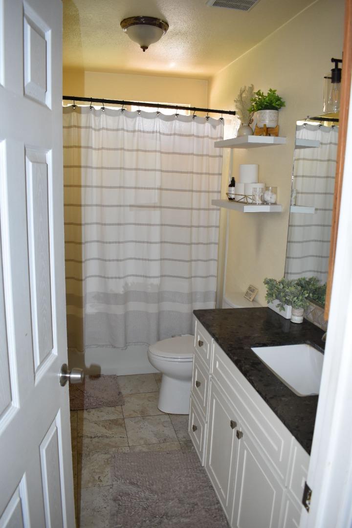 359 North 3rd Street Grover Beach, CA 93433 - Photo 14 of 23 a bathroom with a granite countertop sink toilet and shower
