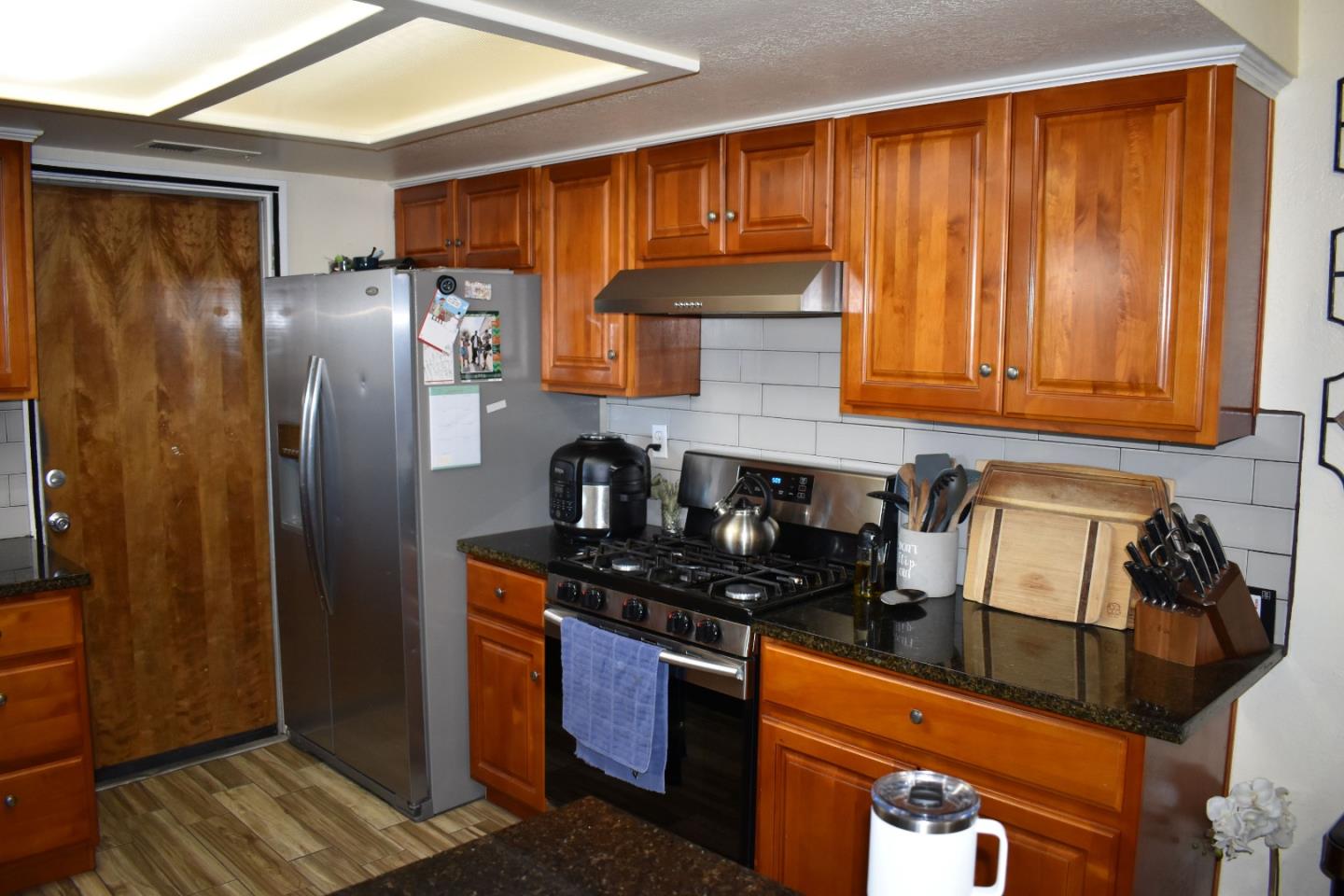 359 North 3rd Street Grover Beach, CA 93433 - Photo 18 of 23 a kitchen with granite countertop stainless steel appliances a refrigerator a sink a stove and cabinets