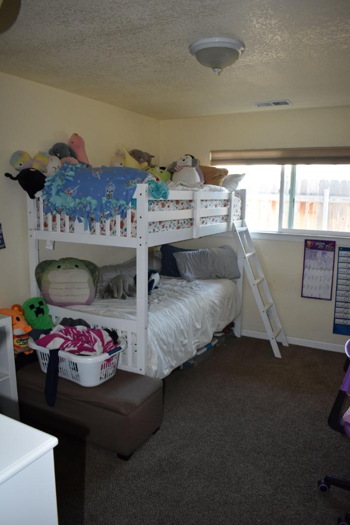 359 North 3rd Street Grover Beach, CA 93433 - Photo 20 of 23 a bedroom with a bed and a table