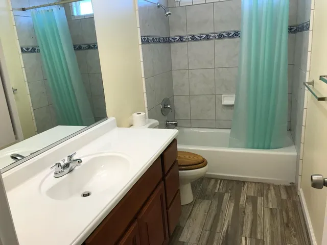 a kitchen with granite countertop a sink stove and refrigerator