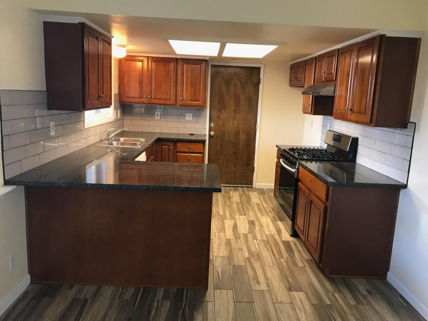 359 North 3rd Street Grover Beach, CA 93433 - Photo 10 of 10 a kitchen with granite countertop a sink stove and refrigerator