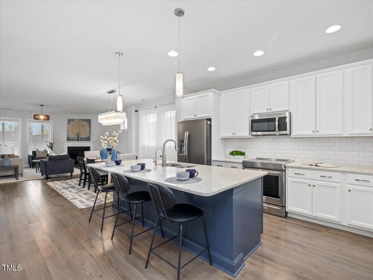 173 Hawk Point Road Chapel Hill, NC 27516 - Photo 12 of 90 Kitchen features upgraded appliances , modern lighting, and gorgeous countertops!